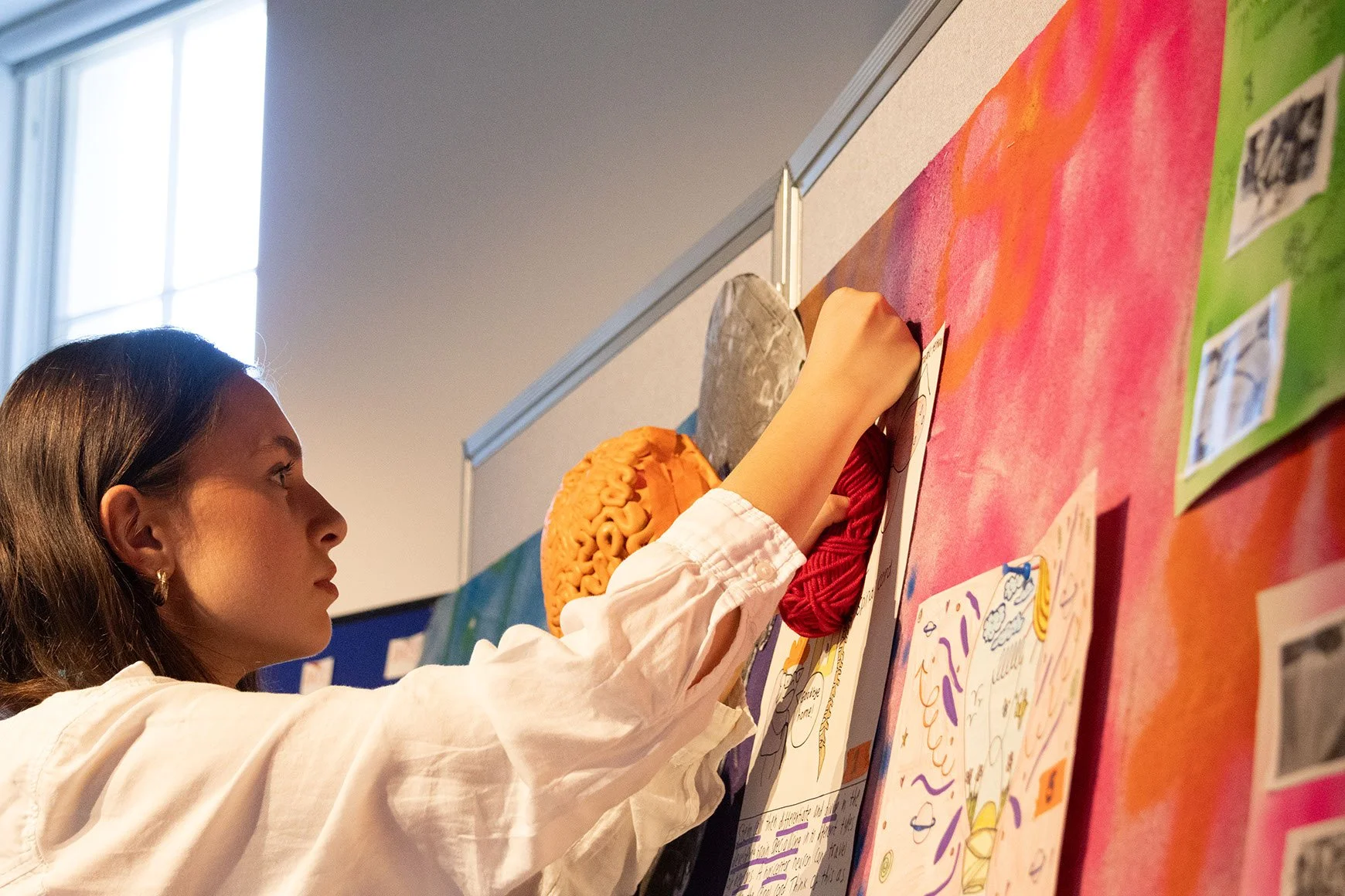 A DNA participant adds final touches to their group project.
