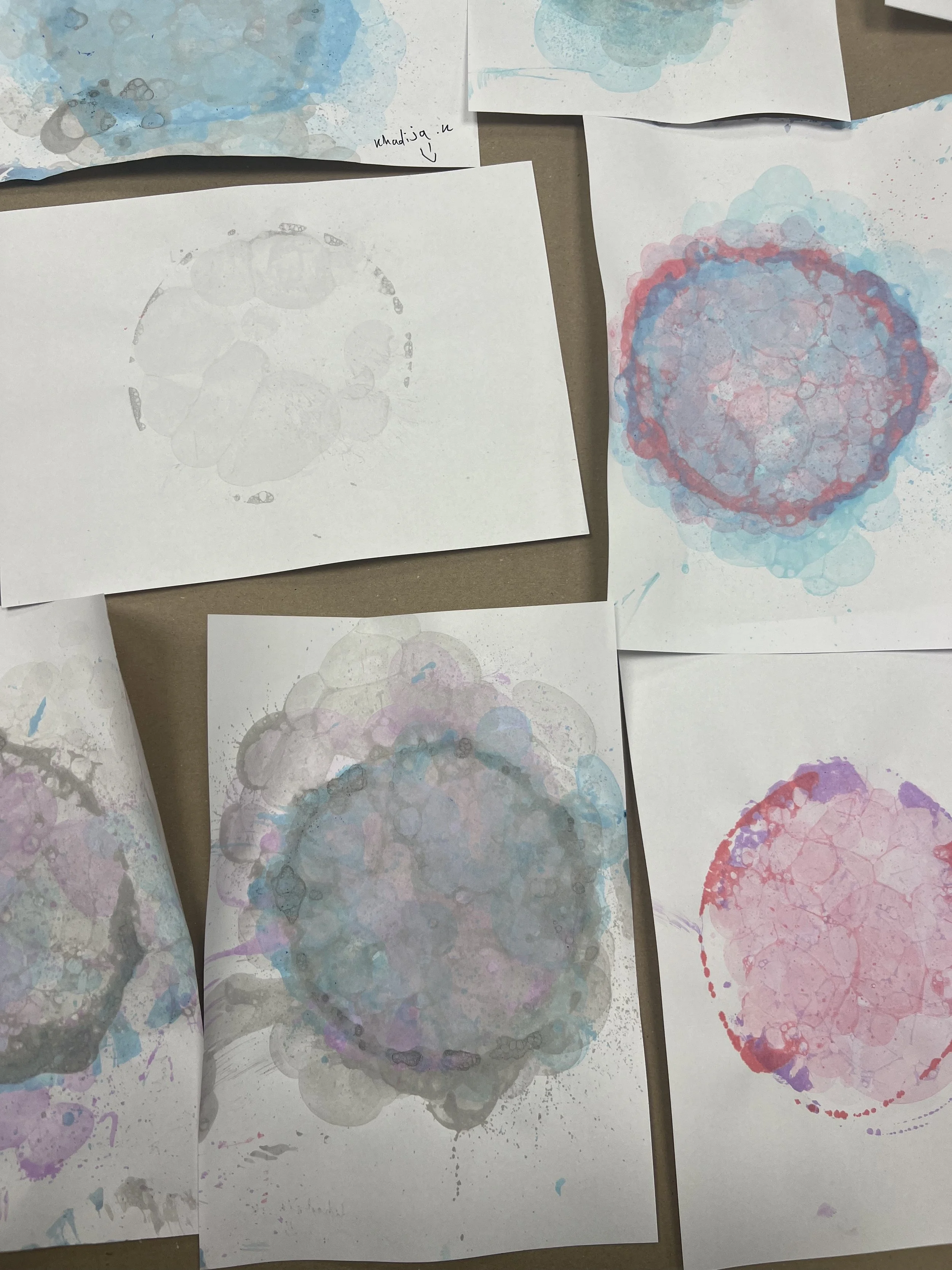Sheets of paper covered in images of colourful bubbles.