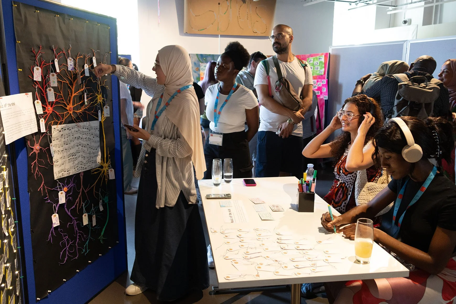 DNA CREATE participants demonstrate their exhibition to guests.