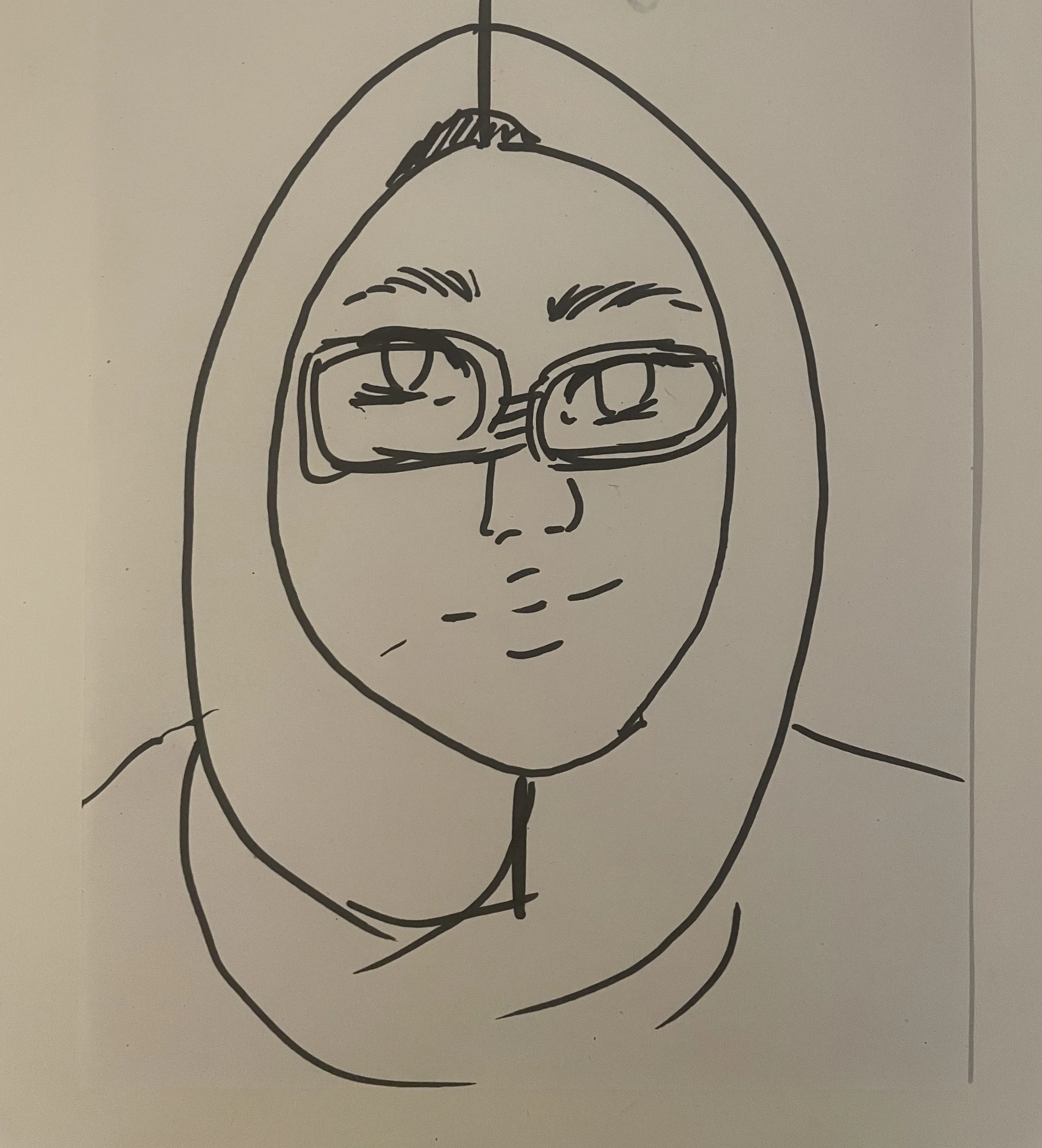A face, slightly smiling, with glasses and a headscarf.