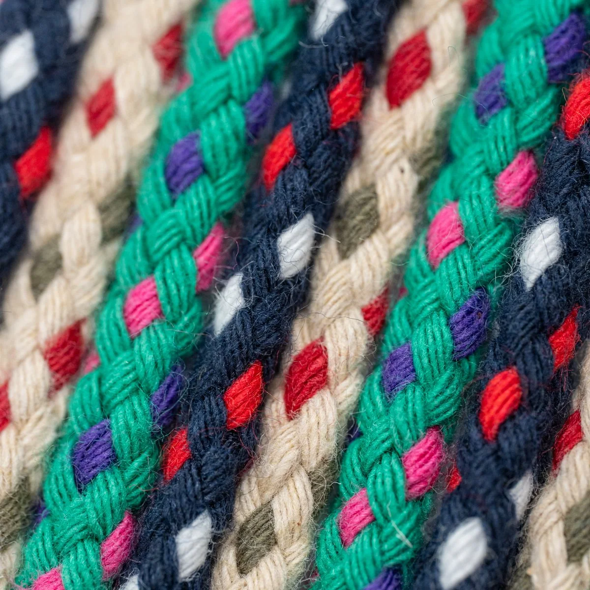 Cordones trenzados en varios colores, incluyendo verde, rojo, azul, blanco, rosa, morado y beige.