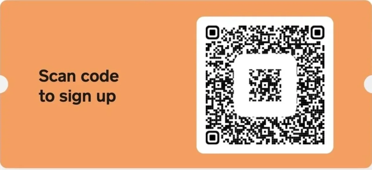 Orange sign with black text that says 'Scan code to sign up' and a black and white QR code.