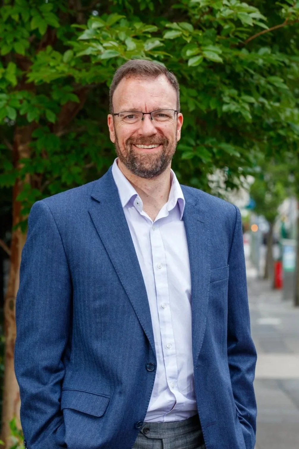 Headshot of Dr Timothy Doyle, Clinical Psychologist, standing outdoors smiling at camera