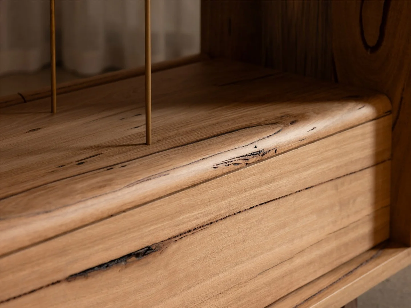 Close-up of a wooden furniture piece with visible natural grain, knots, and imperfections in the wood.