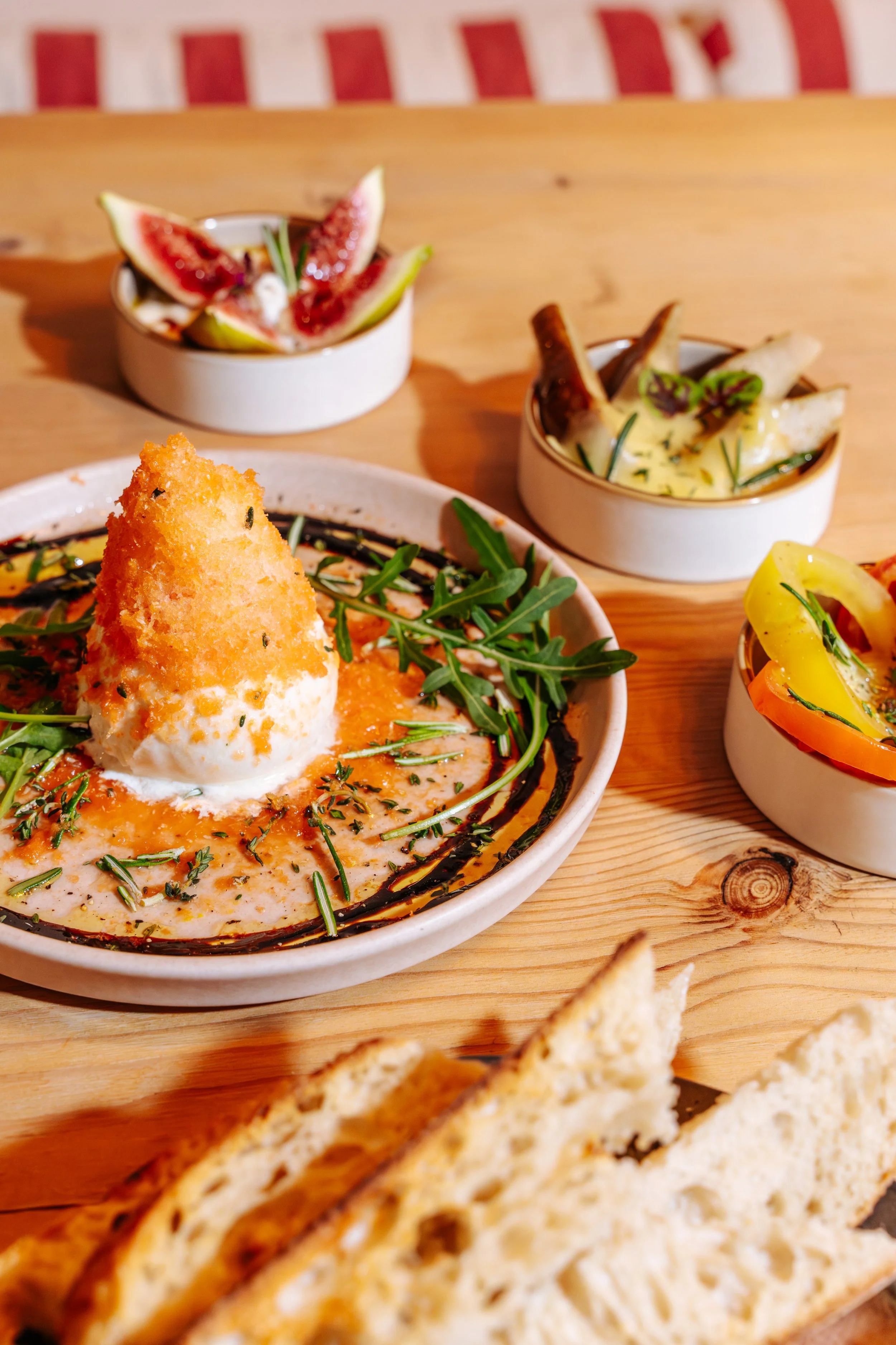 Assorted dishes with vegetables and bread on a wooden table