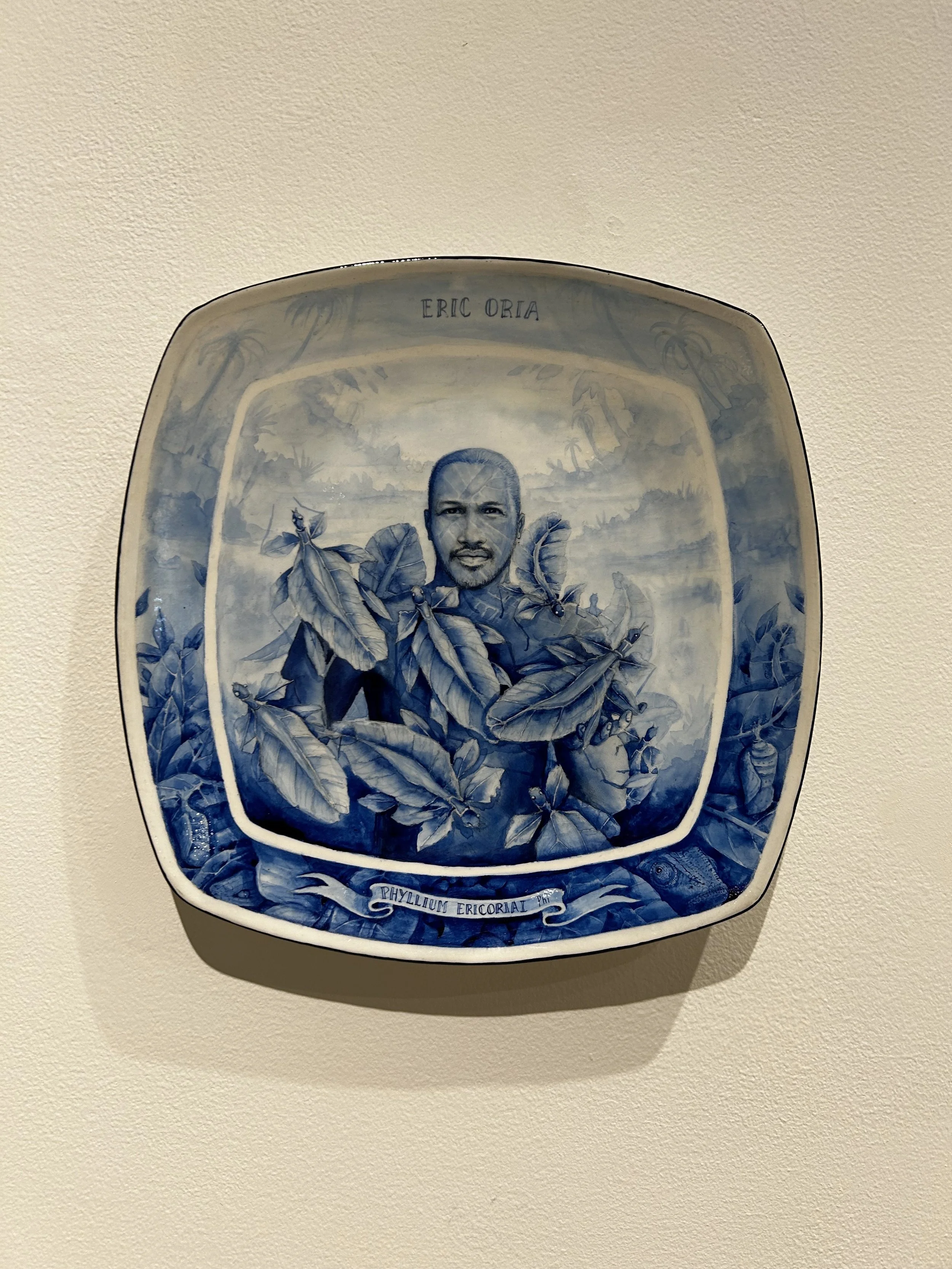 Painting on man covered in leaves on found plate