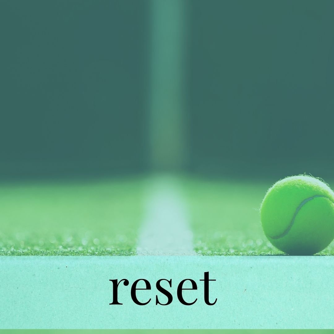 A close-up of a green tennis ball on a tennis court with the word 'reset' written at the bottom.