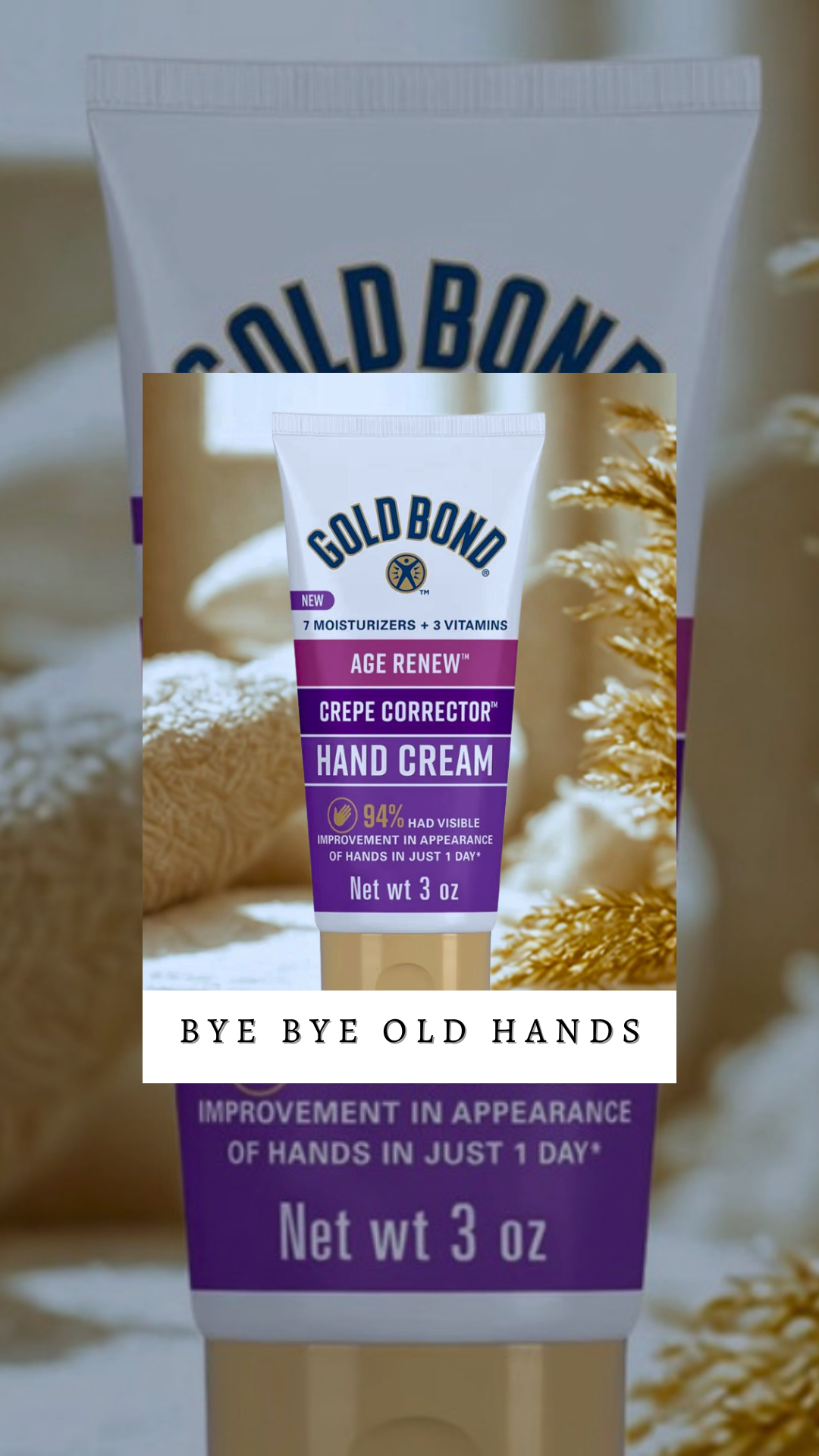 A tube of Gold Bond Age Renew hand cream with purple and white packaging, placed on a soft towel with dried flowers in the background.