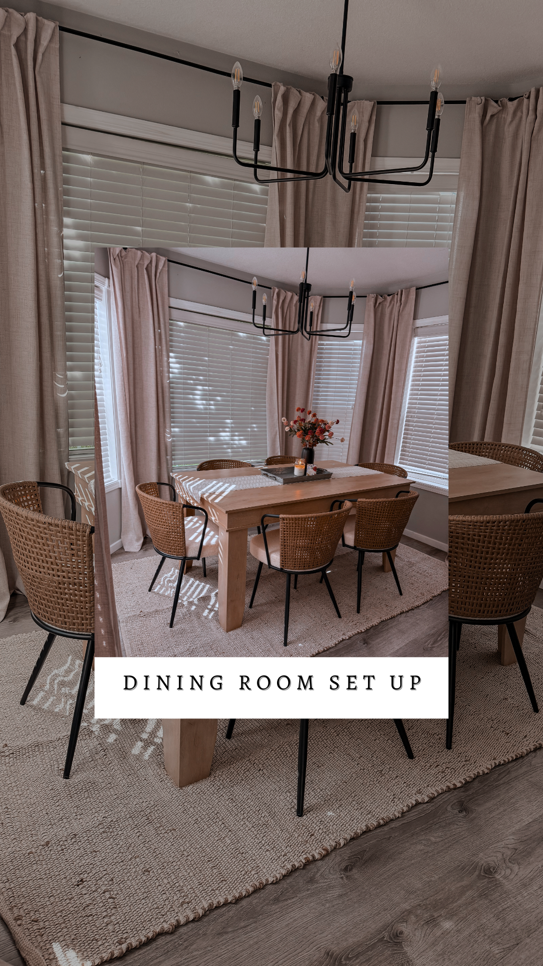 Dining room setup with a wooden table, six woven chairs, a bouquet of flowers, and large windows with blinds and beige curtains. Overhead chandelier with candle-style lights.