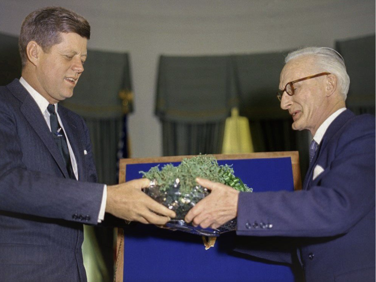 Irish Ambassador presents President John F. Kennedy with the shamrock bowl in the Oval Office, a strategic tradition started in 1952 to keep Ireland in the room at the White House.