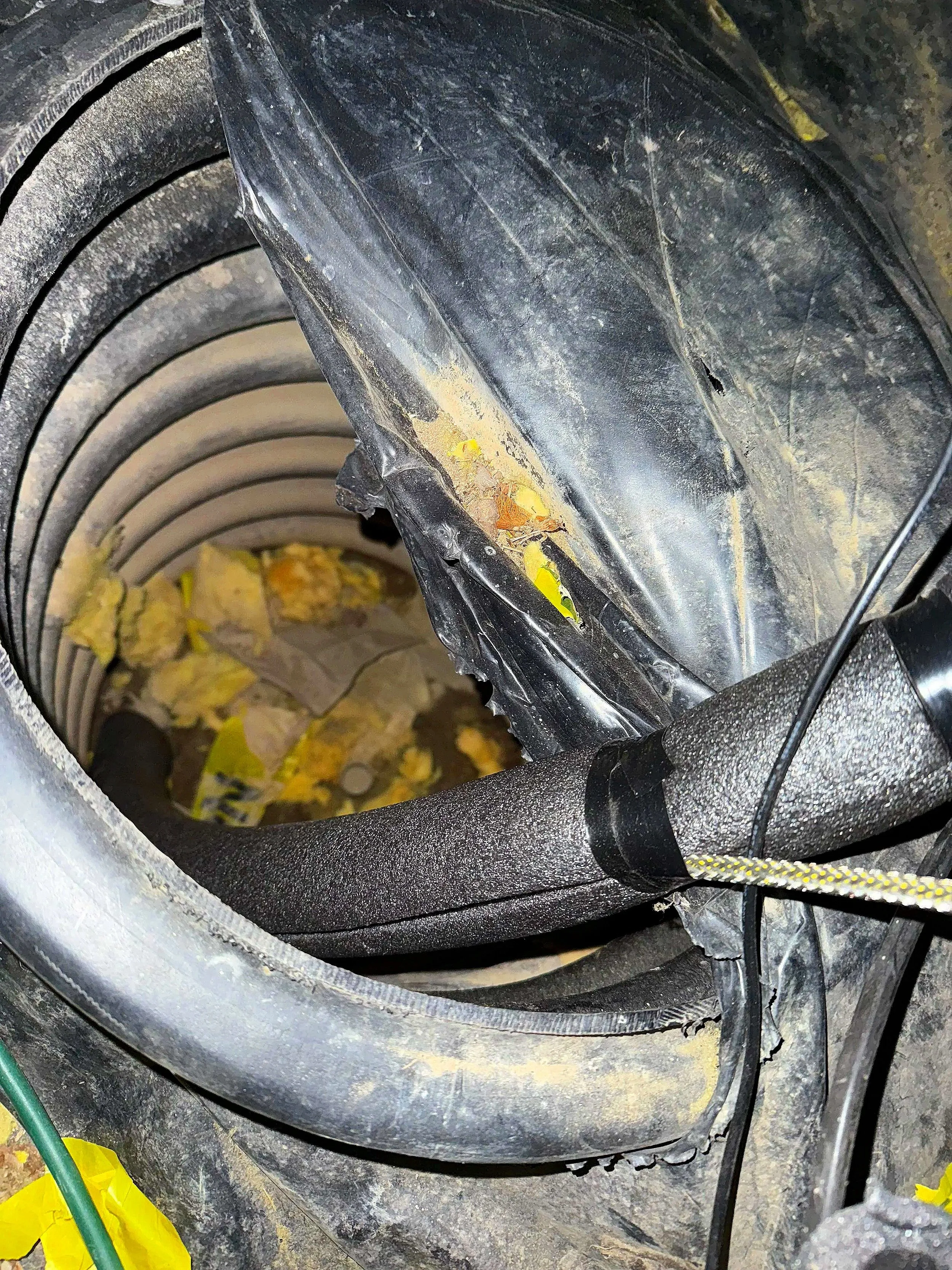 A close up of a manufactured and mobile home crock were the main water line runs with pipe foam insulation and a newly installed heat tape.