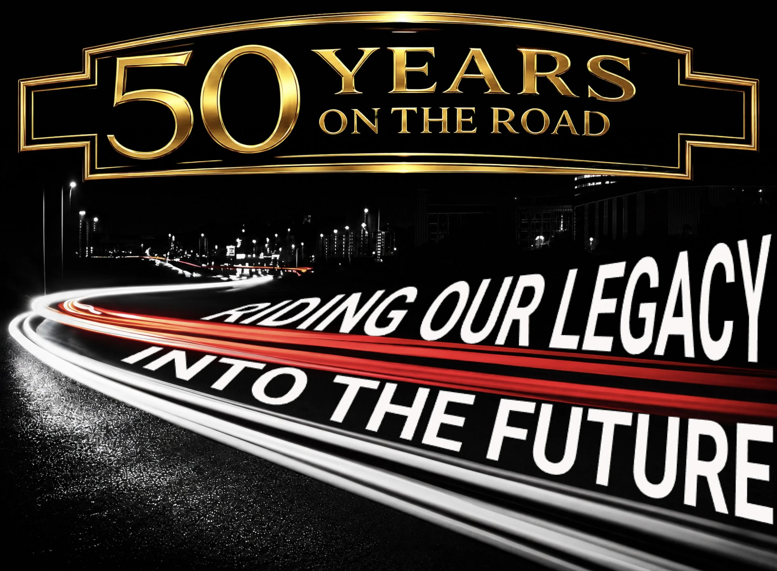 A lit-up sign at night celebrating 50 years on the road, with streaks of car lights on an urban street below.
