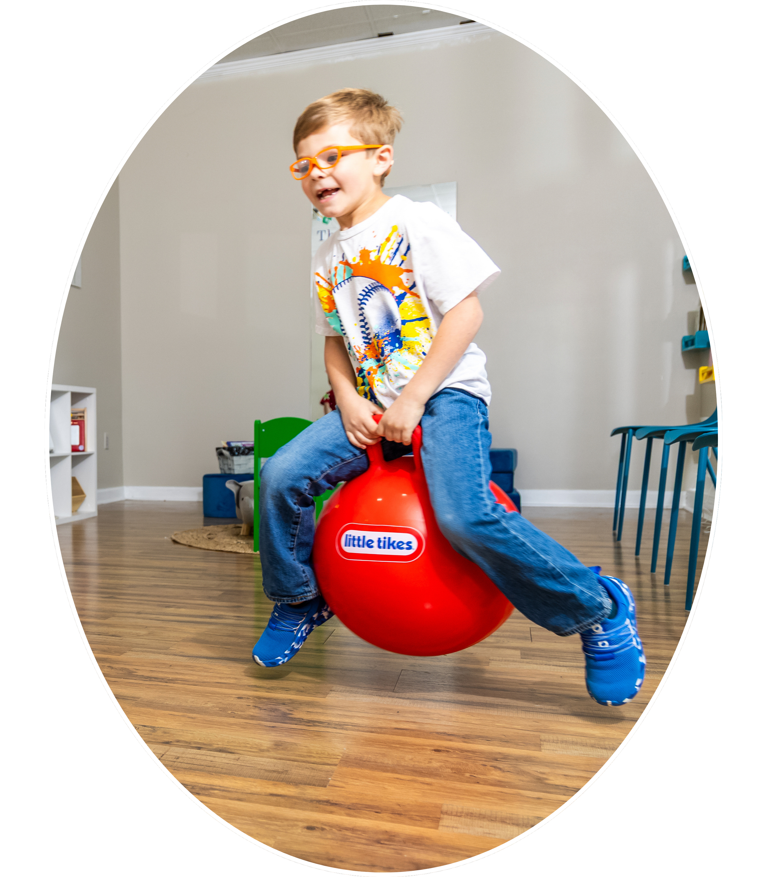hild bouncing on therapy ball during play session at Wellspace Play Therapy in Madison and Huntsville, Alabama