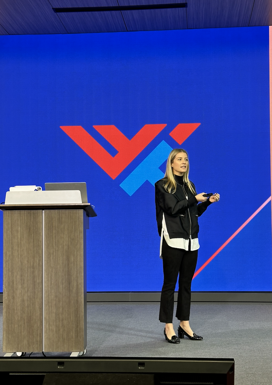 Laura K. Sawyier is standing on a stage speaking at World Wide Technology.