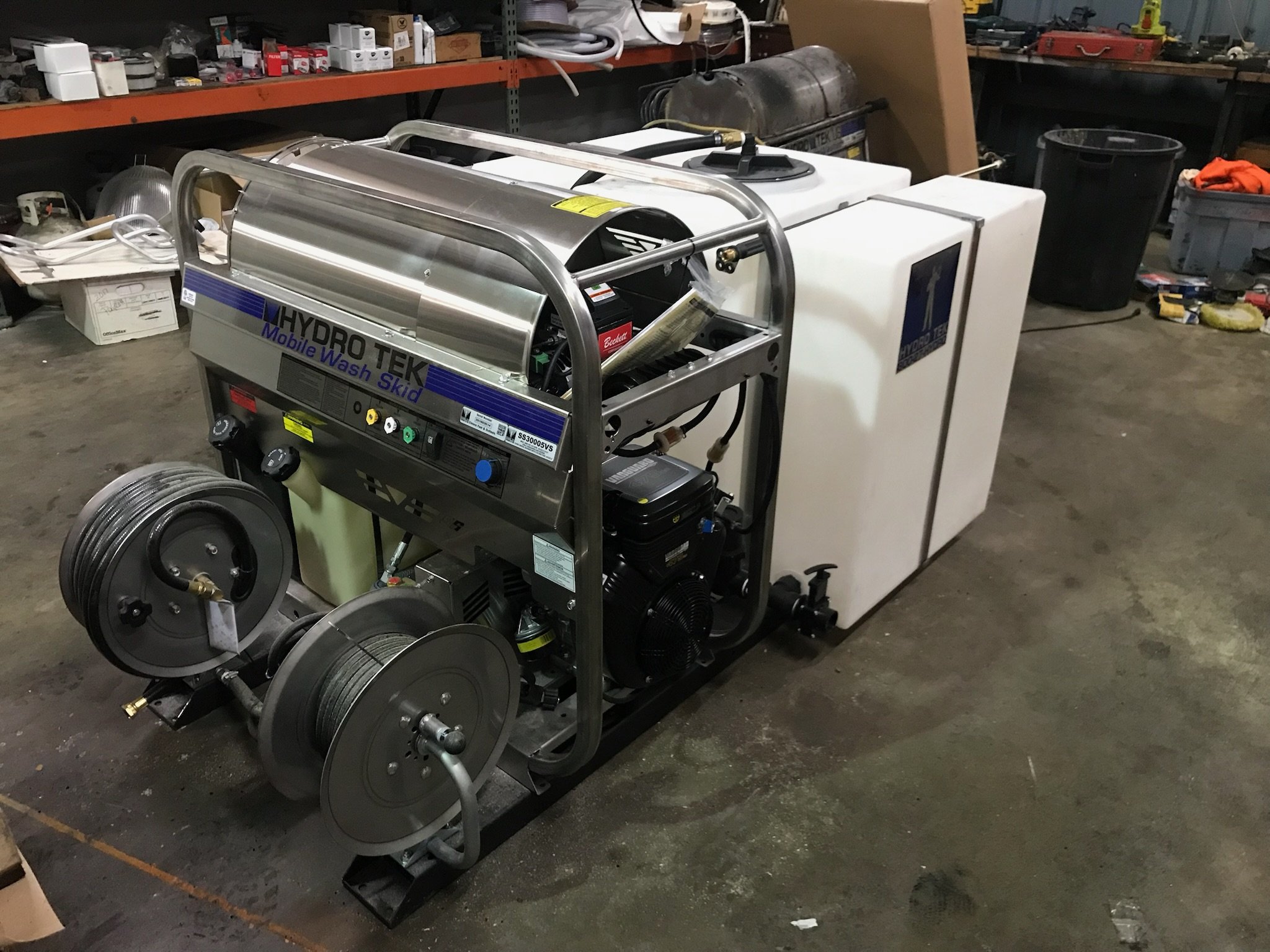 Hydro Tek mobile wash skid in a workshop with hose reels and water tank.