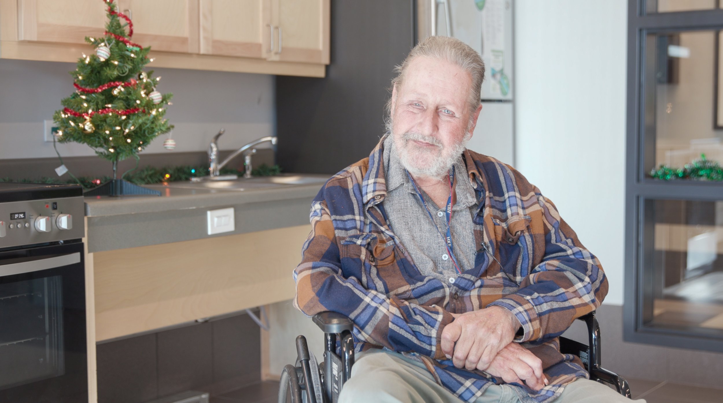 Keith Larson, an Over the Rainbow Association resident, seated in his wheelchair inside his accessible apartment building