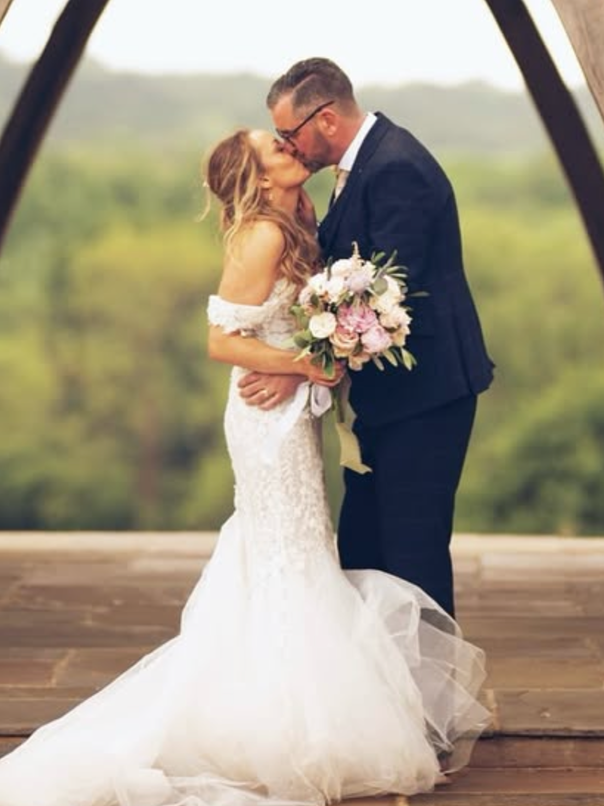 Bride and groom with pastel bouquet