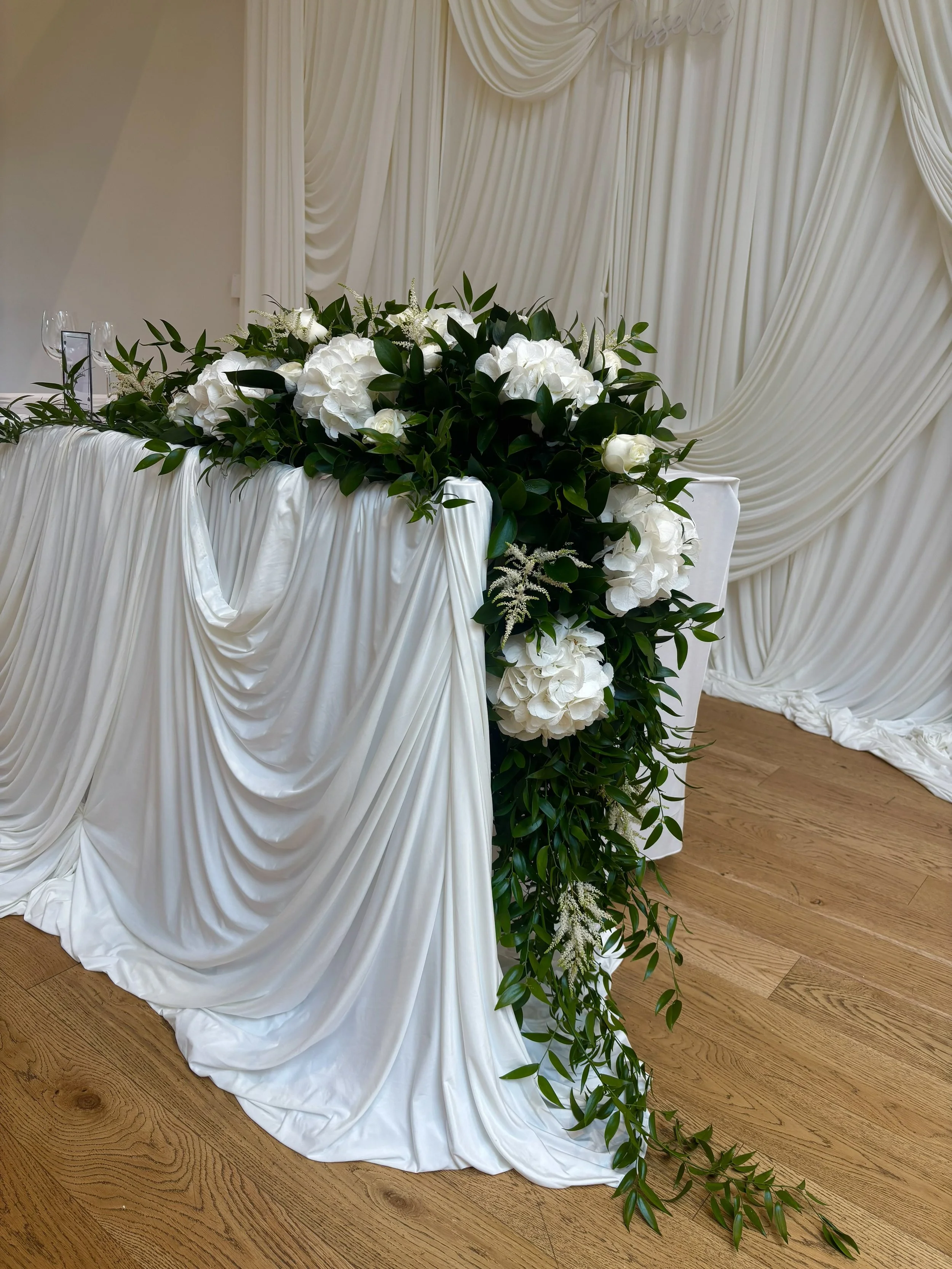 Table runner with greenery and white Hydrangeas