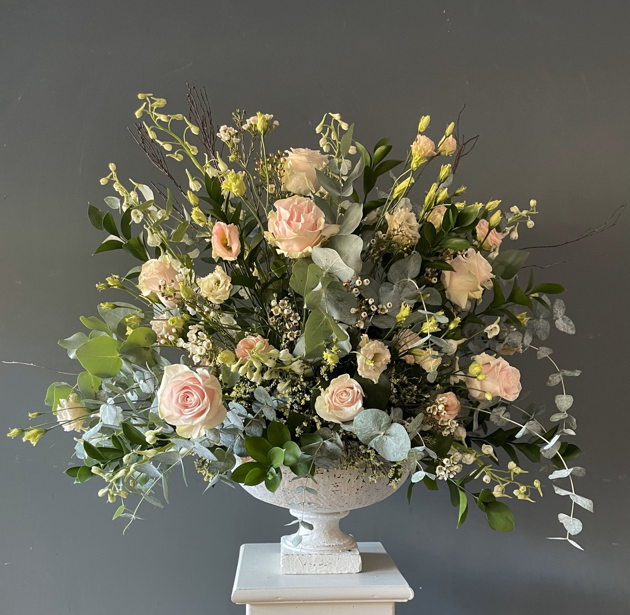 Pedestal arrangement with peach Roses and Eucalyptus