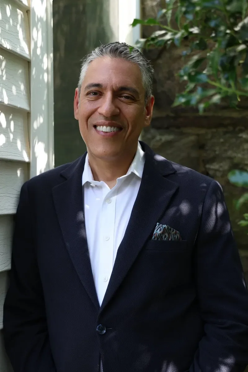 raymond rodriguez standing outside wearing suit