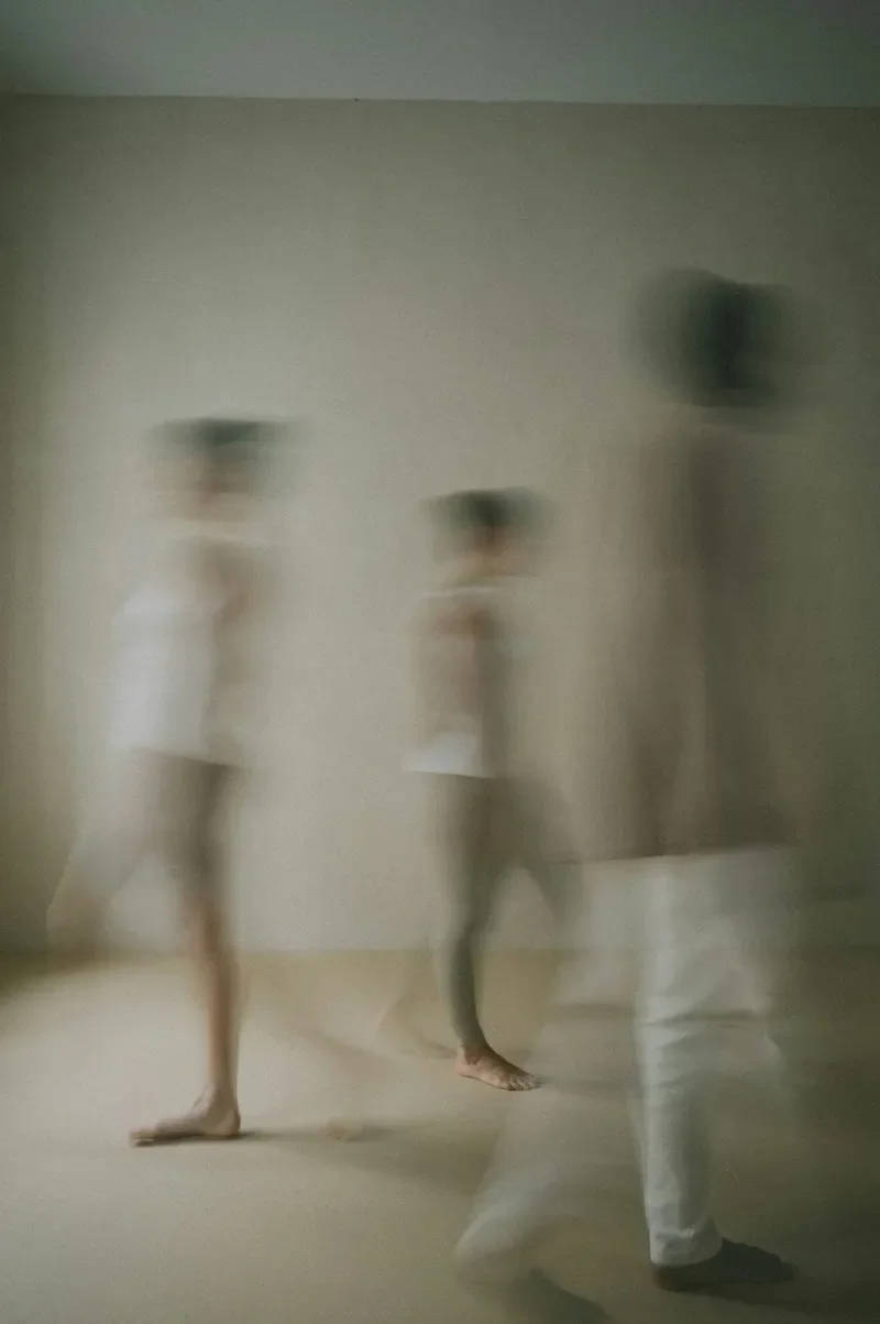 three dancers blurred in motion