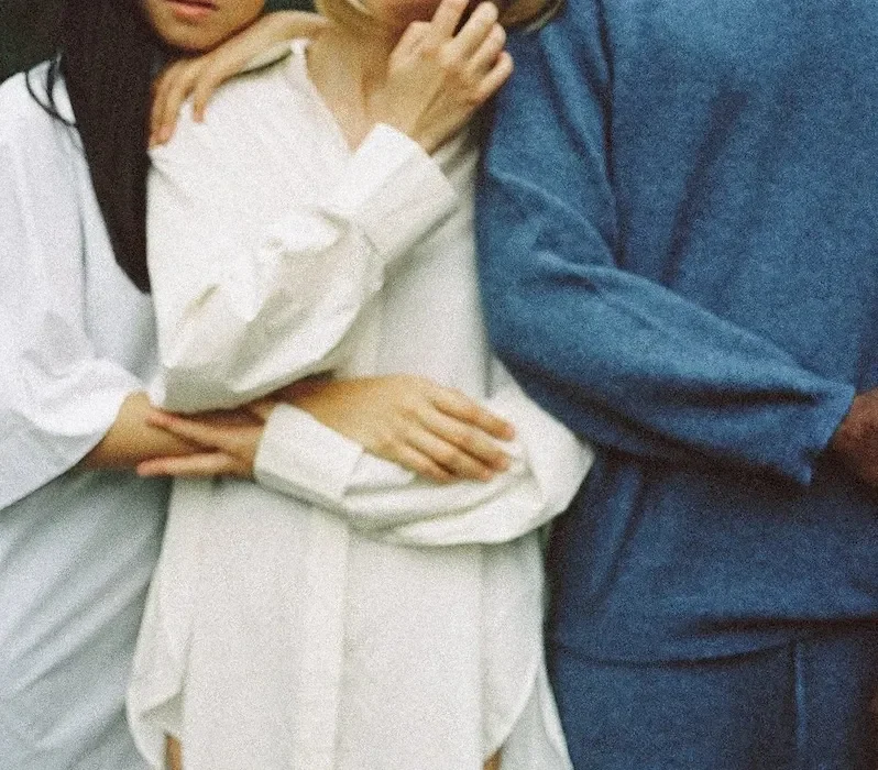 three people standing closely together