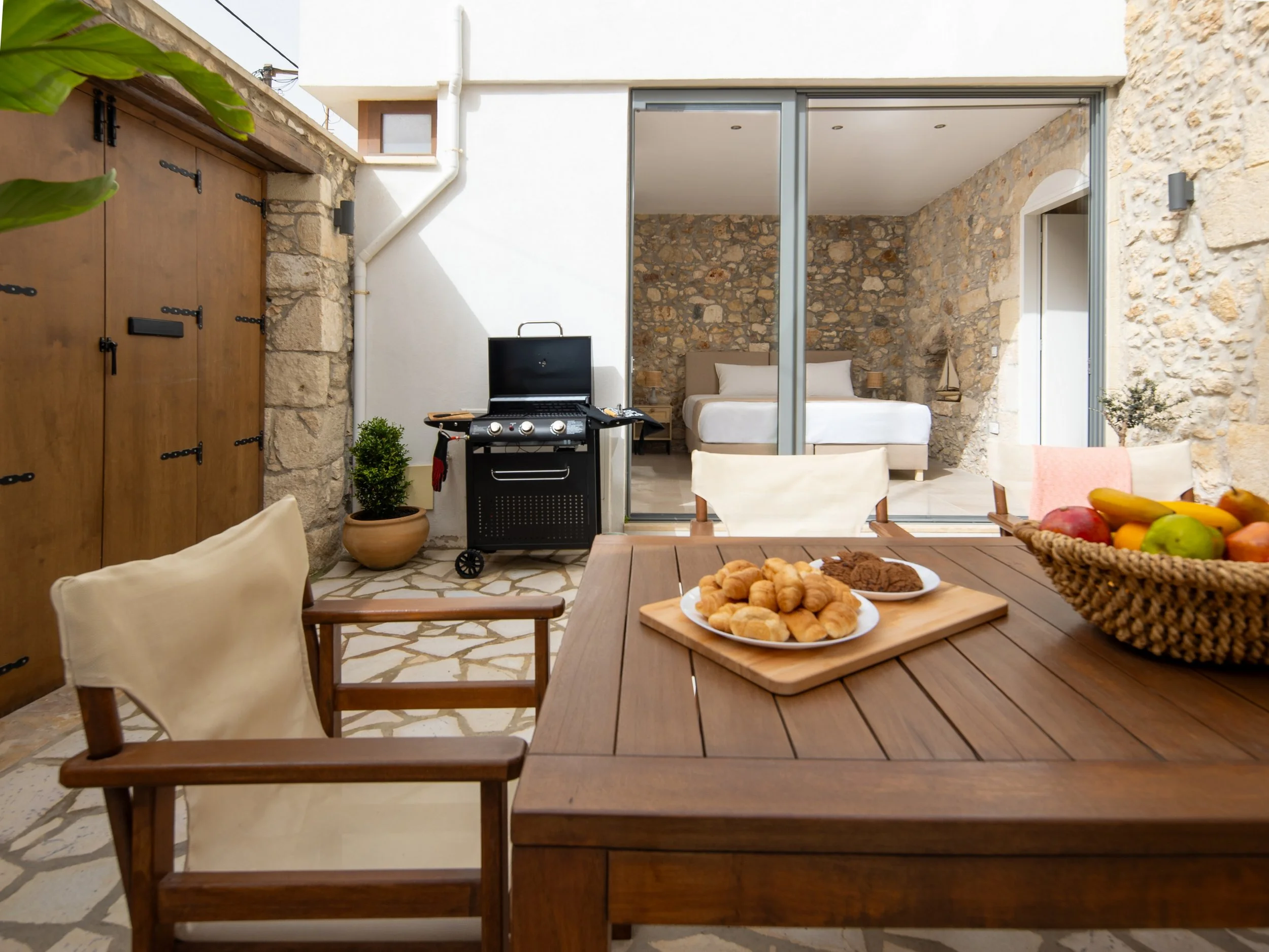 Spacious backyard patio with outdoor dining area and BBQ