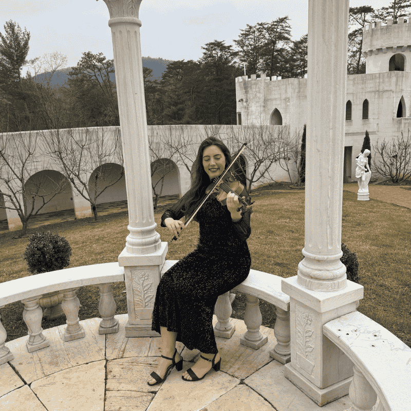Teacher helping a student with violin and piano fundamentals during an in home lesson in Gardena in the South Bay
