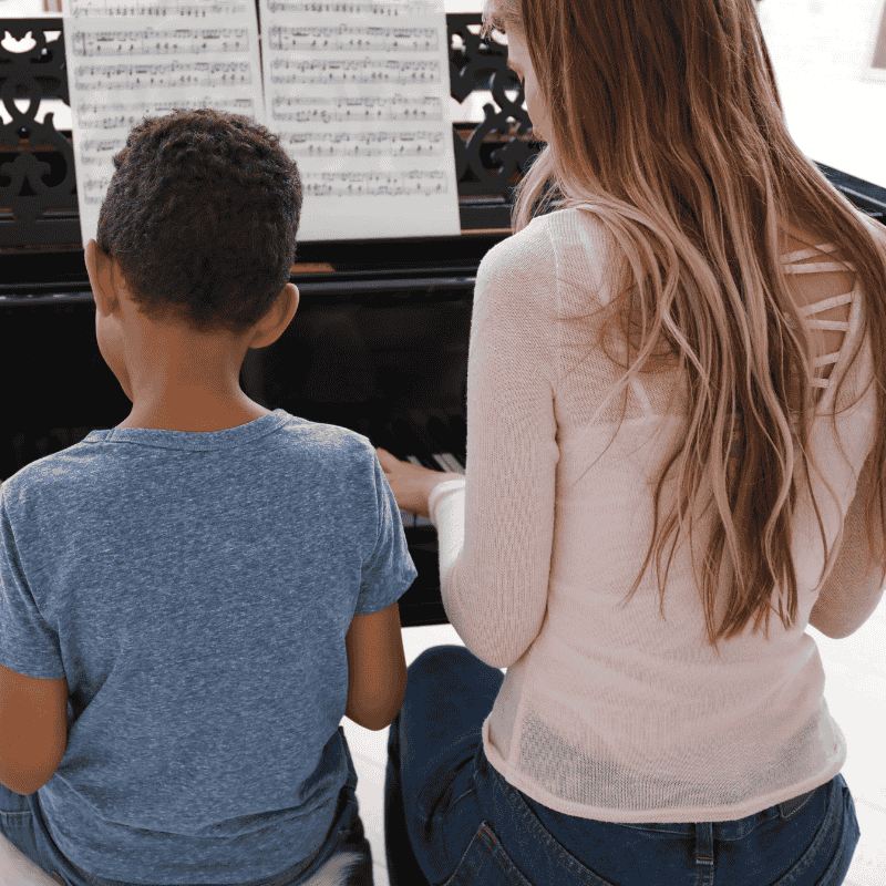 Teacher helping a young student during an in-home piano lesson in the South Bay