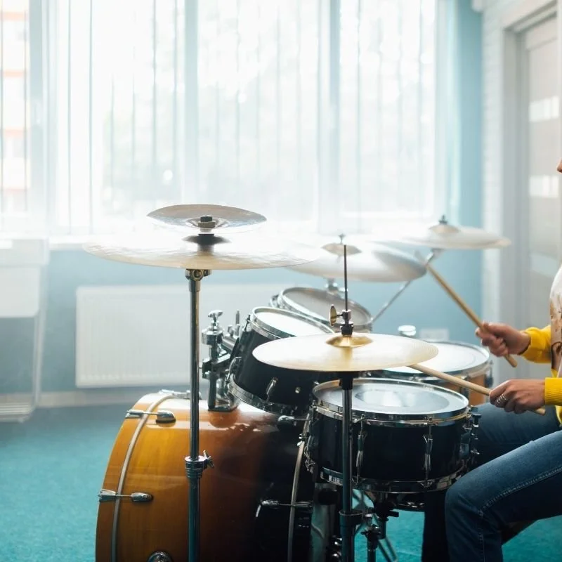 Beginner drum student improvising on drum set during in-home lesson with private teacher in South Bay