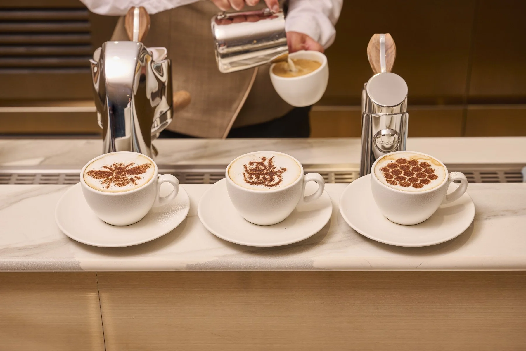A barista prepares coffee in Emirates’ new Manchester Airport lounge