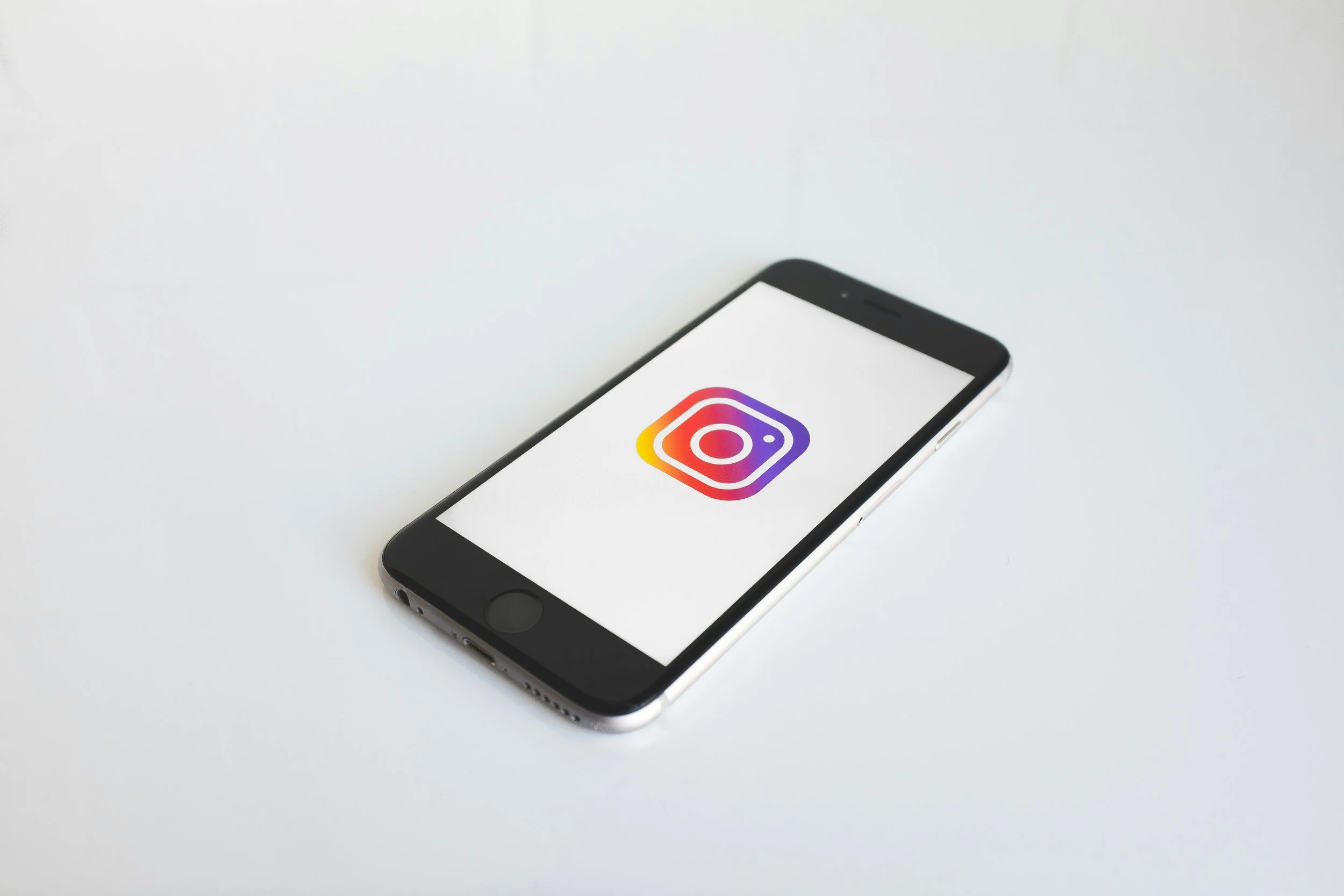 Smartphone displaying Instagram app icon for social media marketing