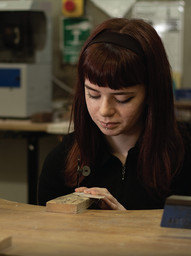 A picture of Anna working at her bench