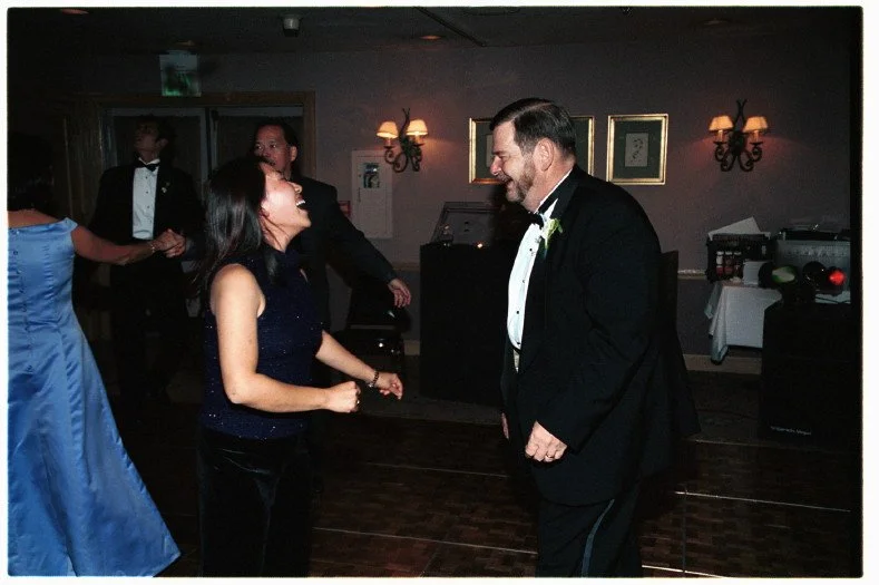 People dancing at a formal event wearing elegant attire