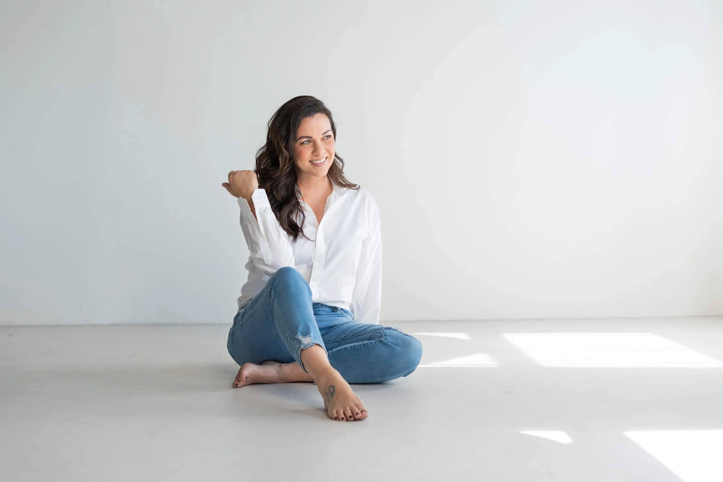 Joey Jamesly's brand photoshoot - she is wearing a white button down with denim jeans