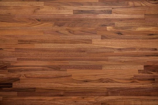 Close-up of a wooden surface, likely a hardwood floor with a natural finish.