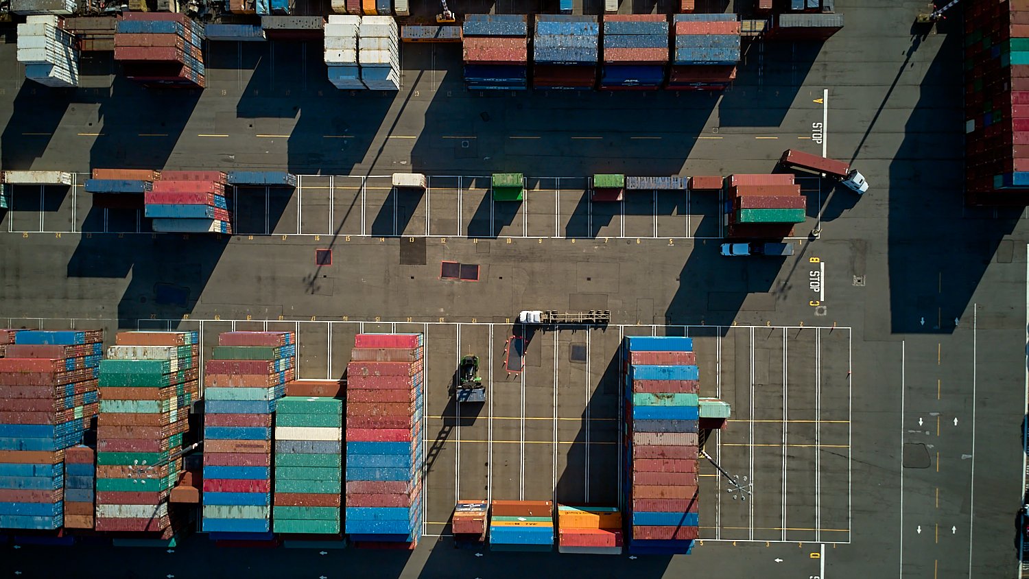 Aerial view of SSA Terminals at the Port of Seattle, featuring container ships and maritime logistics in Elliott Bay.