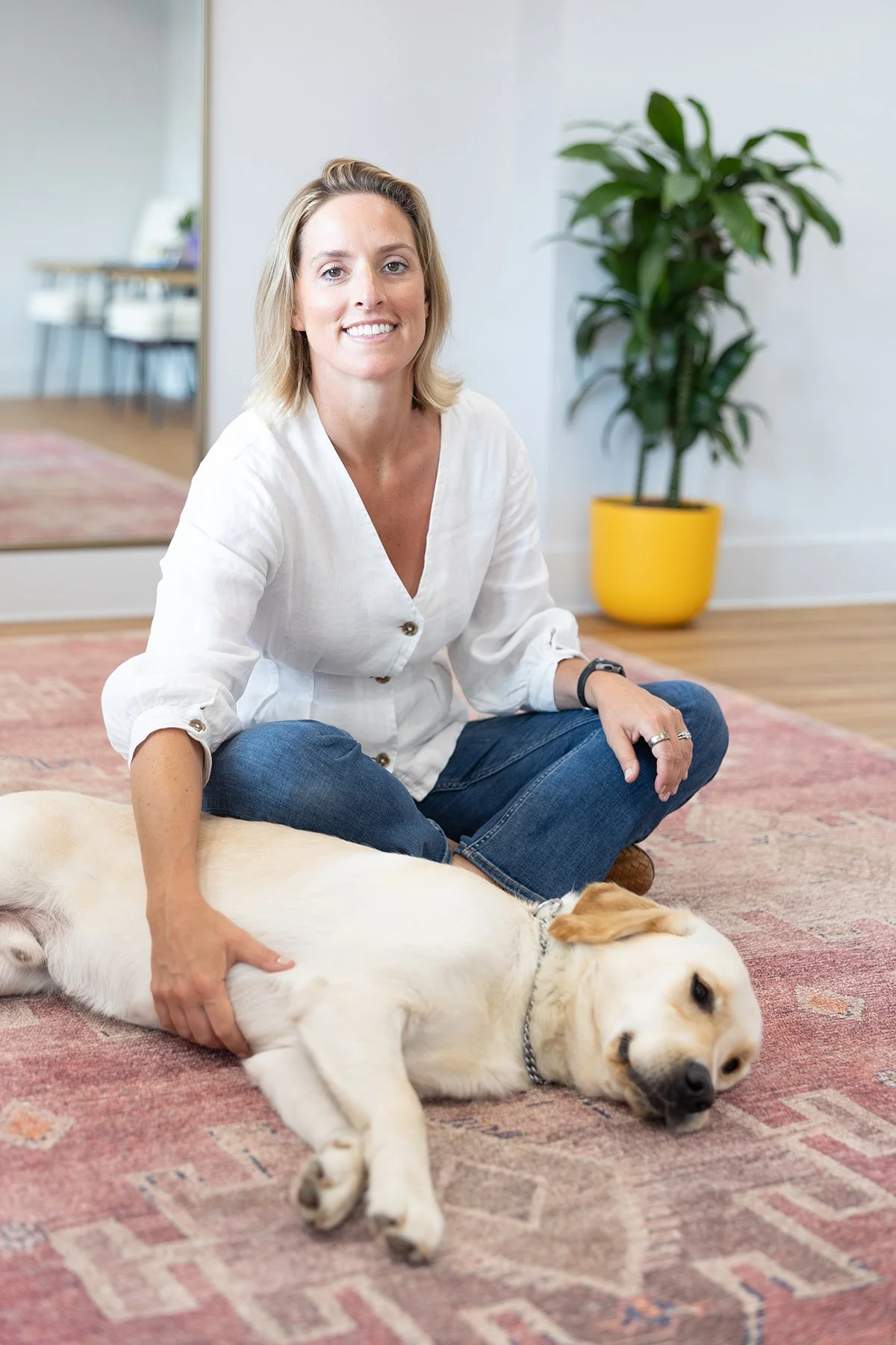 Dr. Liz Simons with Mookie her yellow labrador at Terra Wellness PT