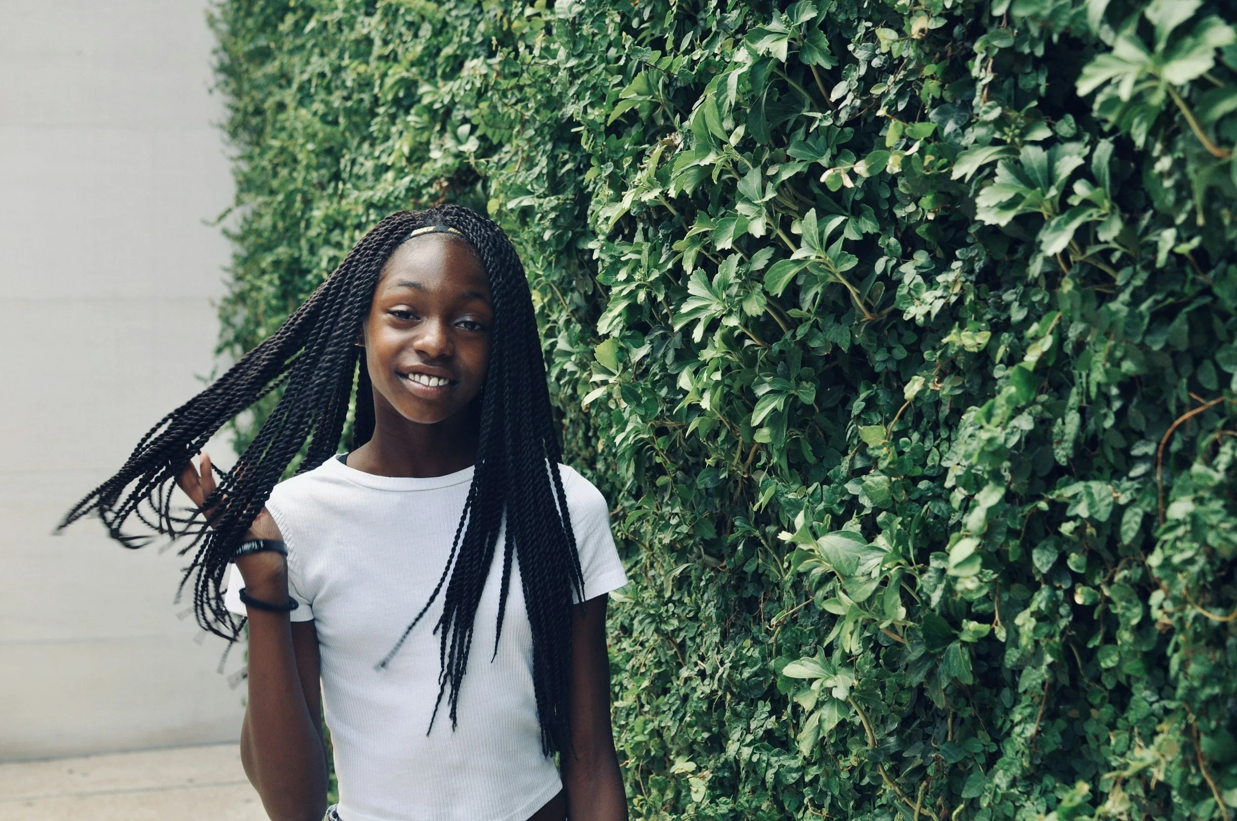 Adolescent girl smiling and tossing her hair