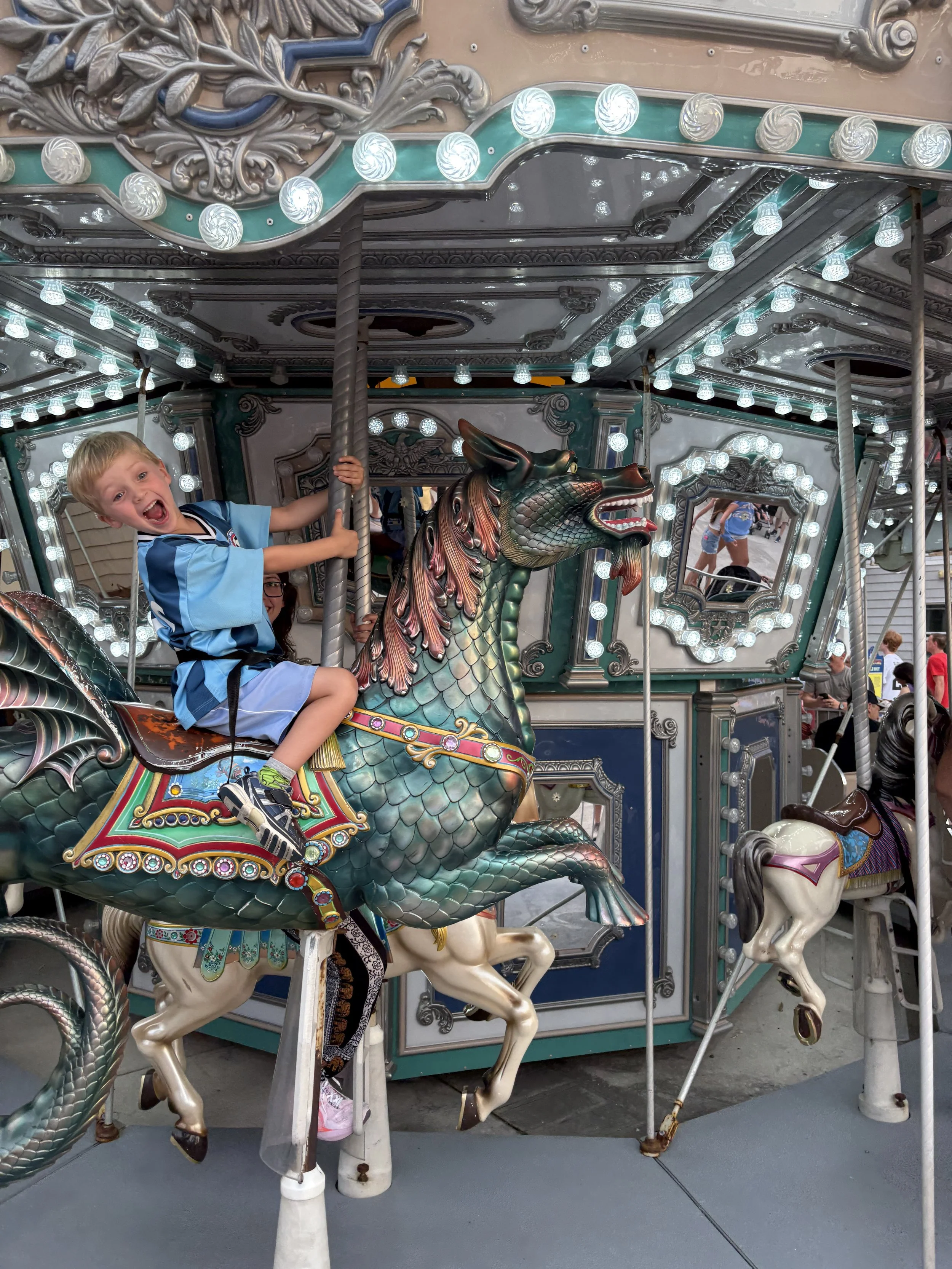 Boy laughing on a merry-go-round