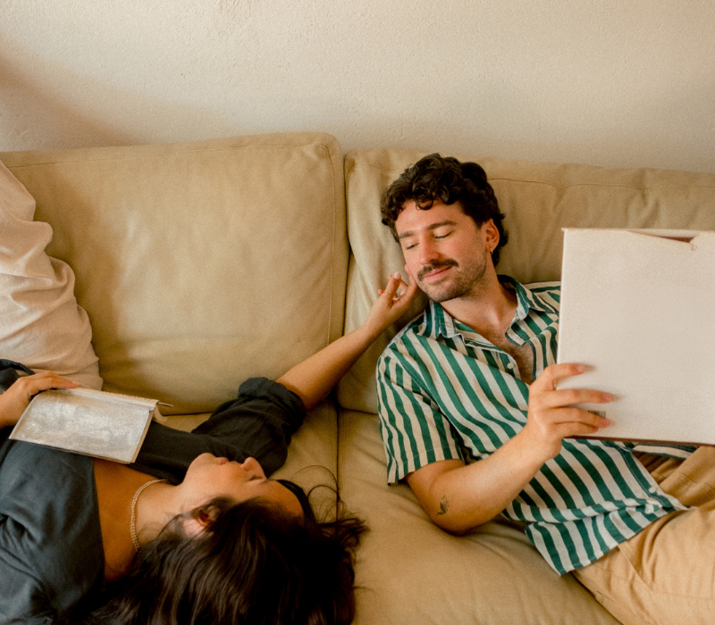 couple on couch reading and relaxing together