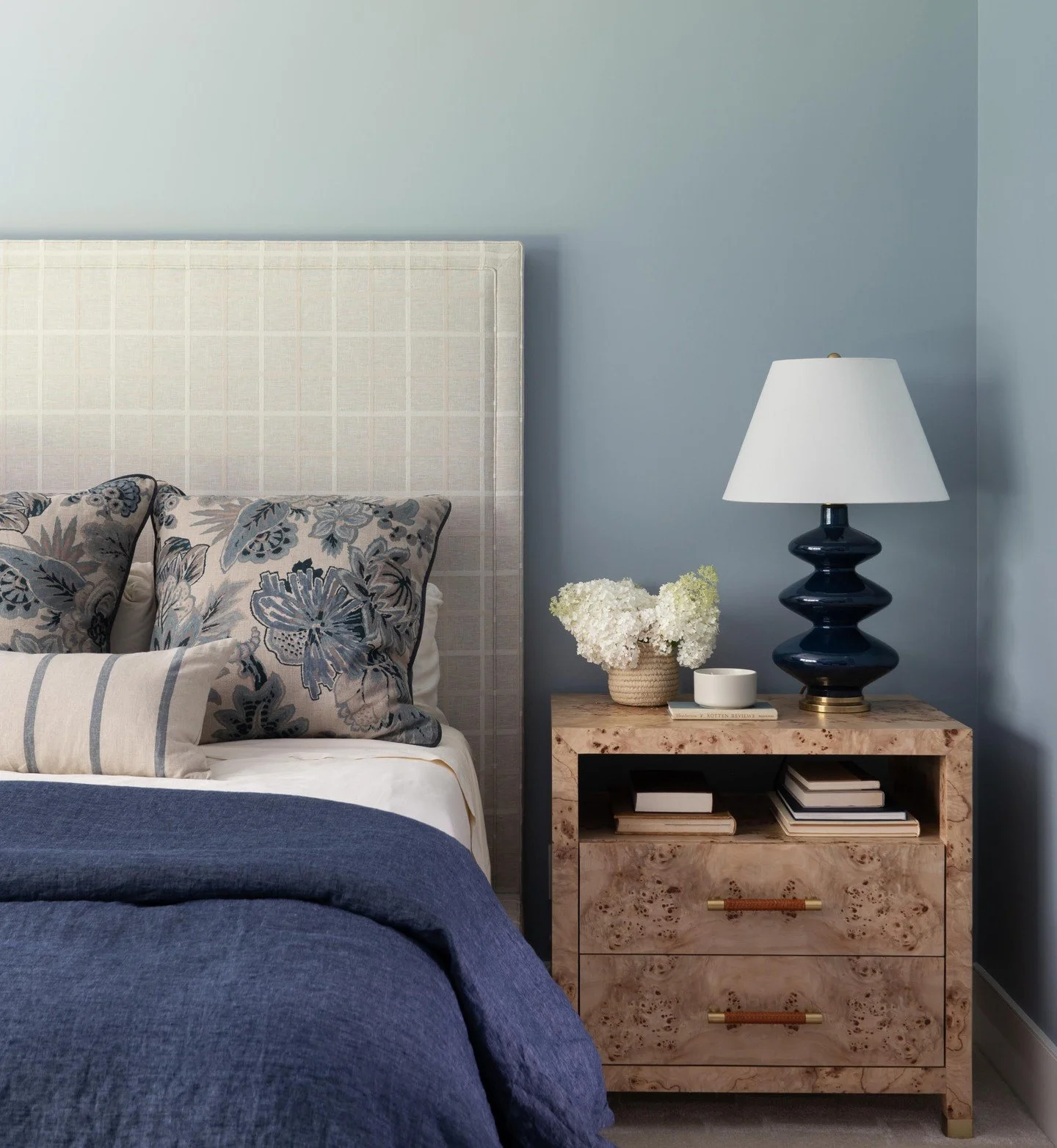 Modern comfort meets timeless design. Textural layers, floral accents, and natural burlwood make this space the perfect end-of-day retreat. 

Photography: @traci.shupert 

#luxurydesign #interiordesign #bedroomremodel #bedroombliss #indianainteriors 