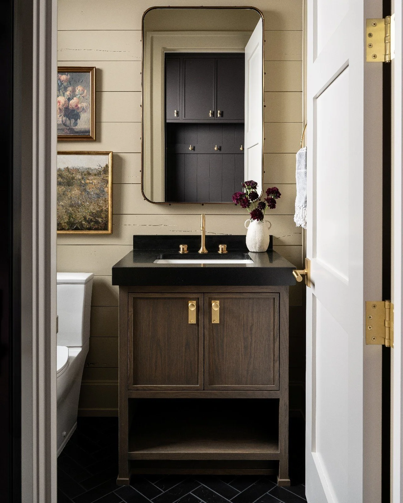 Charm and character pull this powder room together. Repurposed wood shiplap and layered art create a pairing that feels both timeless and thoughtfully collected. 

Builder: @martin.brothers 
Cabinetry: @ayr_cabinet
Photography: @sarahshields

#TheUlt