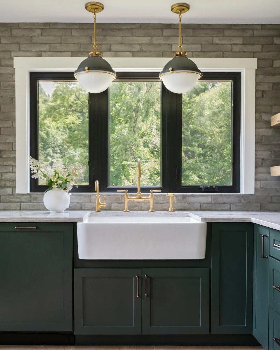 Deep green cabinetry to match the lush springtime view. Who wouldn't want to spend time cooking here?! 

Photography: @traci.shupert

#KitchenDesign #GreenCabinetry #BrassAccents #BridgeFaucet #LuxuryDesign #MidwestDesigner #MapleAndWhiteDesign