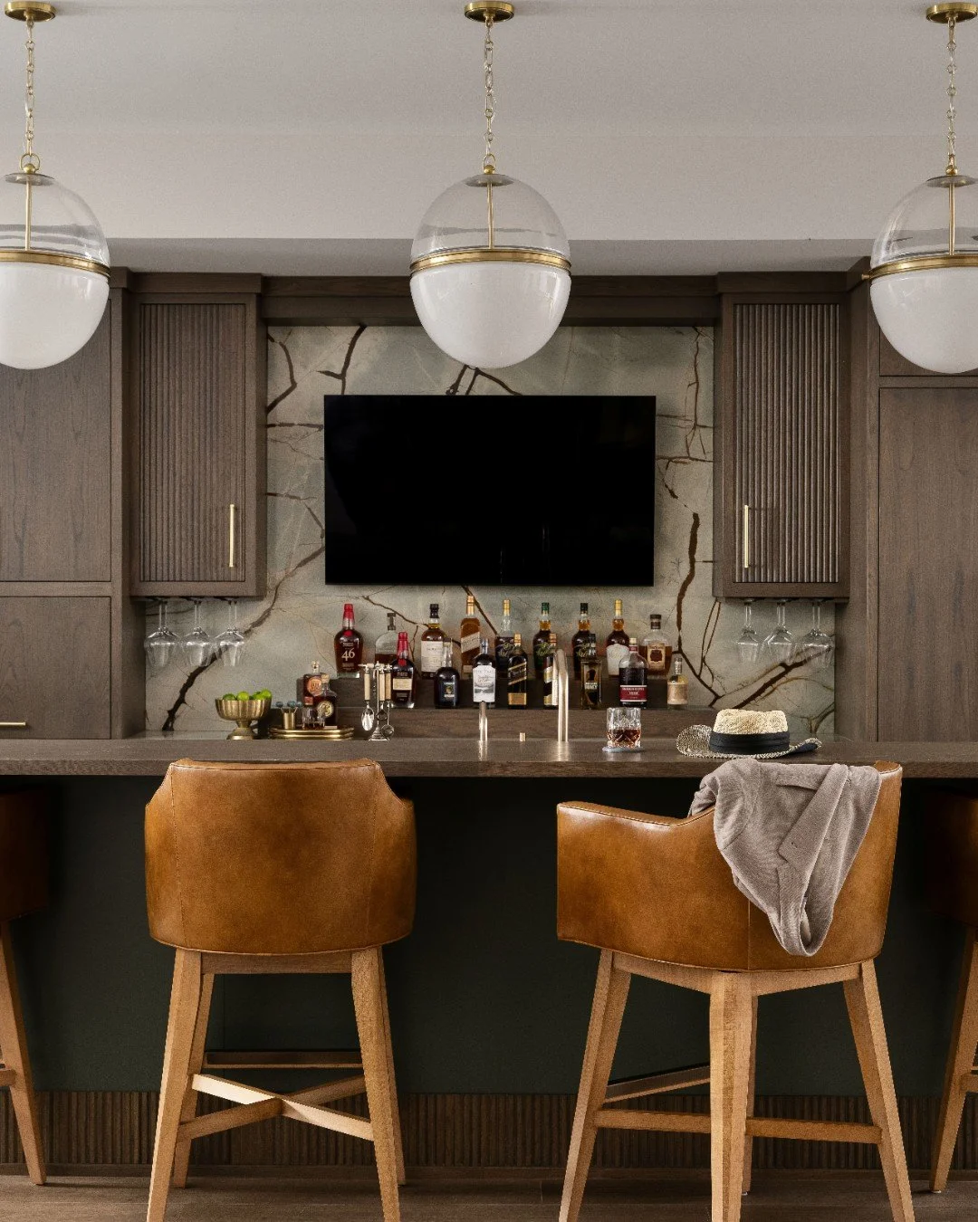 The home bar to end all home bars! To celebrate #WorldCocktailDay, we&rsquo;re serving you inspiration from one of our favorites! 🍸 

Photography: @sarahshieldsphoto
Cabinetry: @ayr_cabinet

#TheUltimateRetreat #HomeBarDesign #BrassAccents #NaturalS
