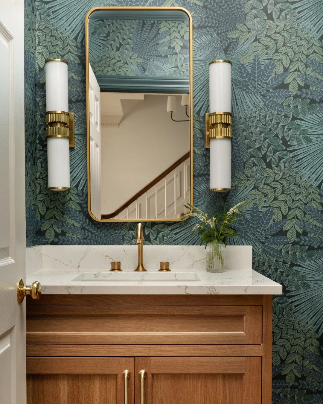 Bold botanical wallpaper, warm wood tones, and brass accents  turn this small powder room into a moody tropical oasis 🌿 

Photography: @traci.shupert
Remodeler: Peacock and Company 

#powderroomdesign #boldwallpaper #brassaccents #luxurydesign #midw