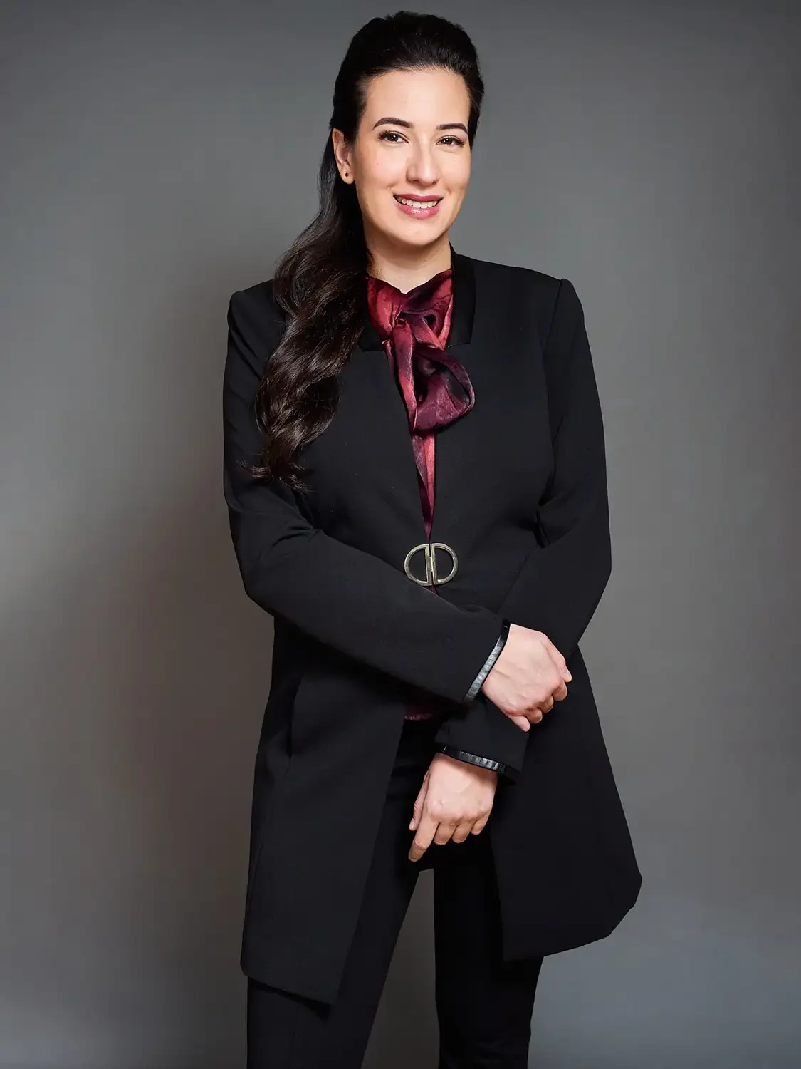 Photo session for bank executive in a black suit with a maroon necktie photographed in a fashionable way.