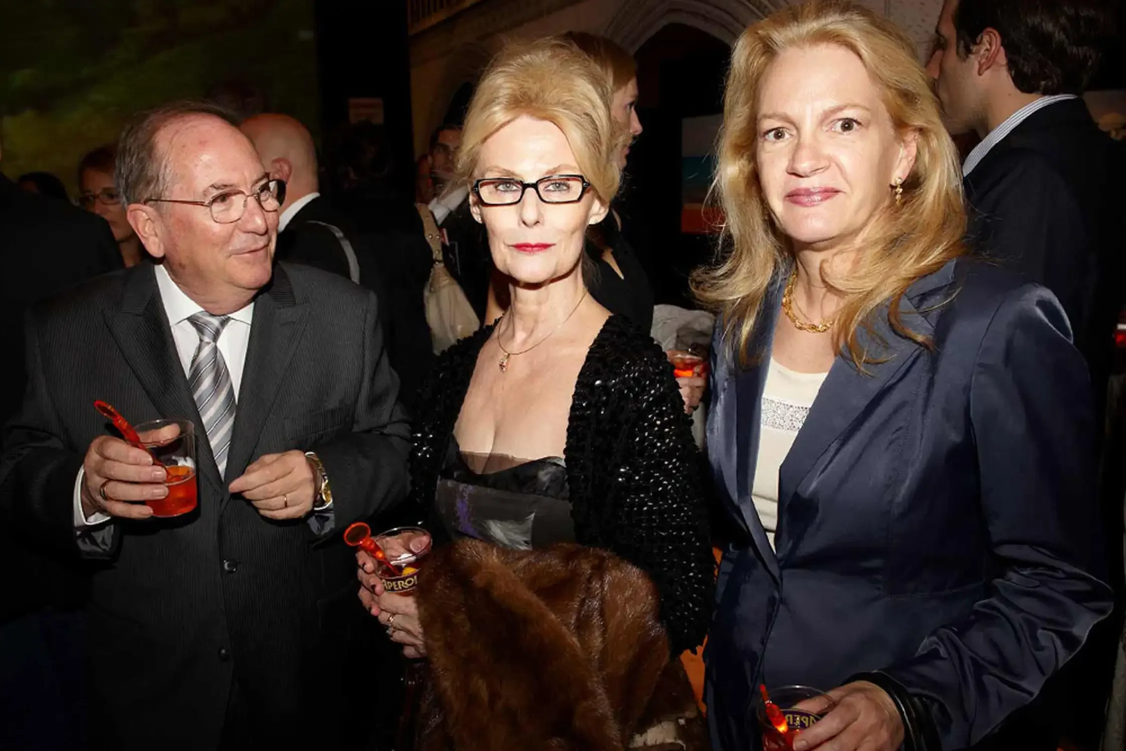 People at a social event, including an older man all elegantly dressed.