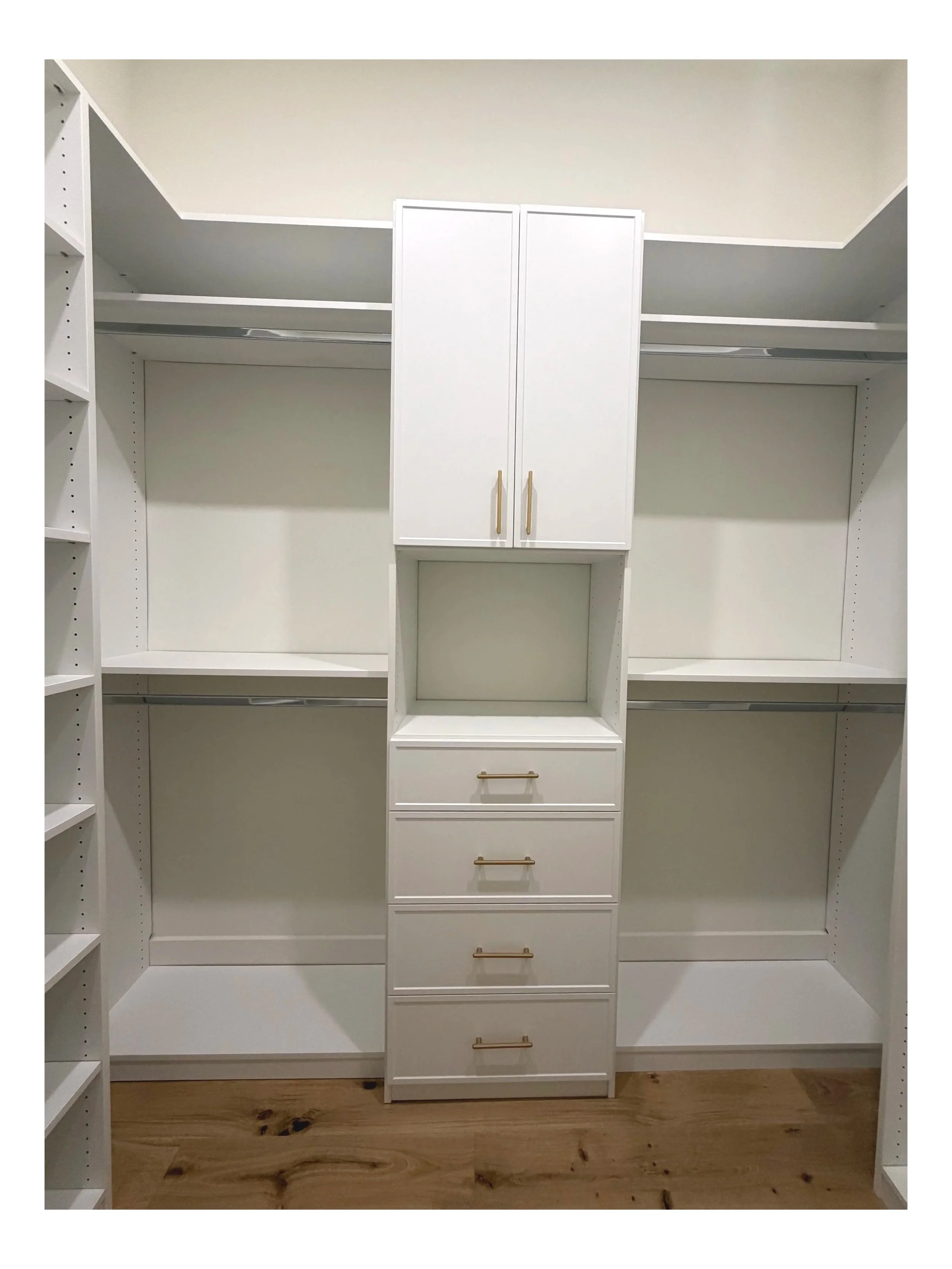 Bright white custom walk-in closet with double hanging sections, built-in drawers, adjustable shelving, and upper cabinet storage with matte gold hardware in a luxury Charlotte, NC home.