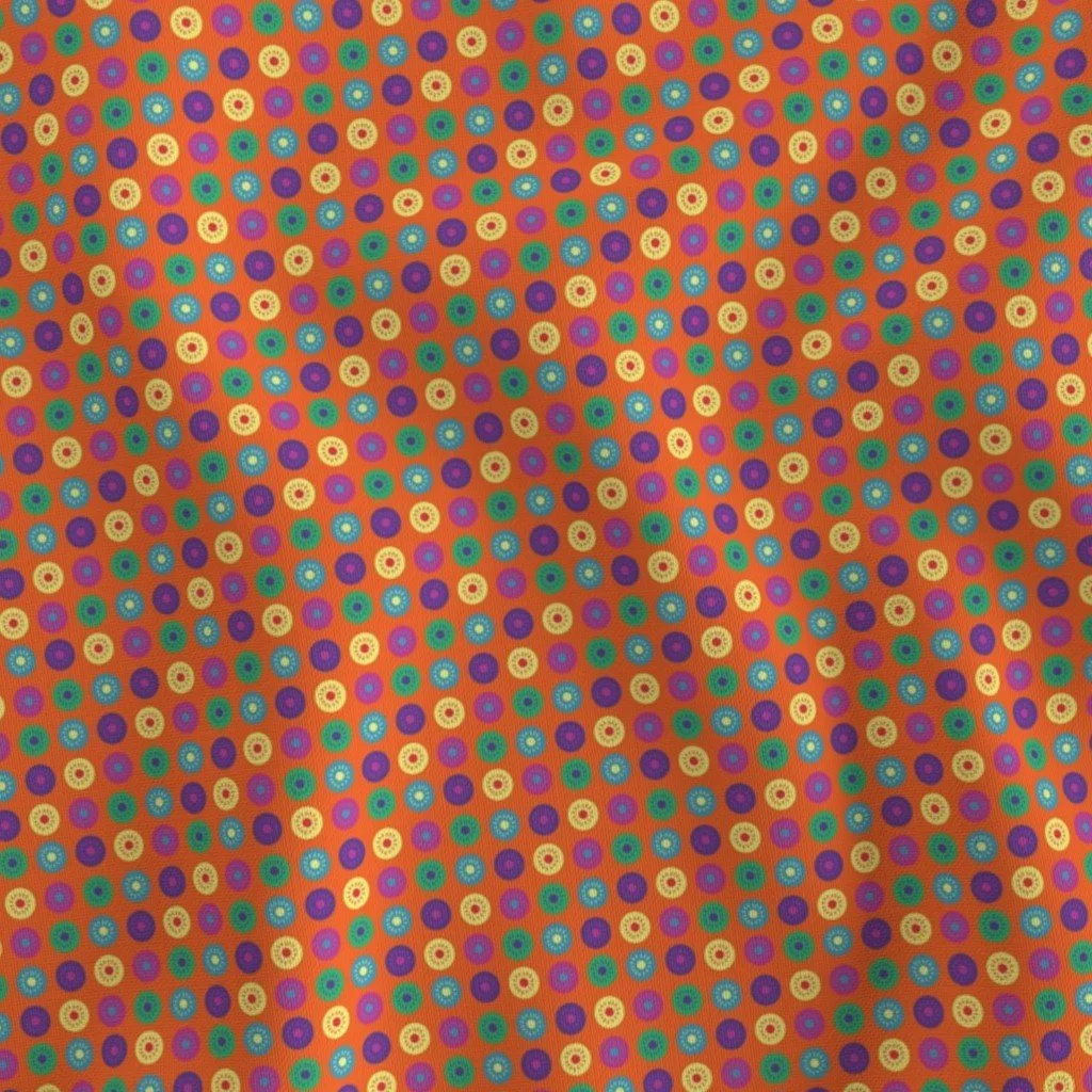 Fabric with a bright orange background with polkadots in various bright colors with inner dots surrounded by lines. Colors include green purple, blue, light blue, dark pink in a repeating pattern